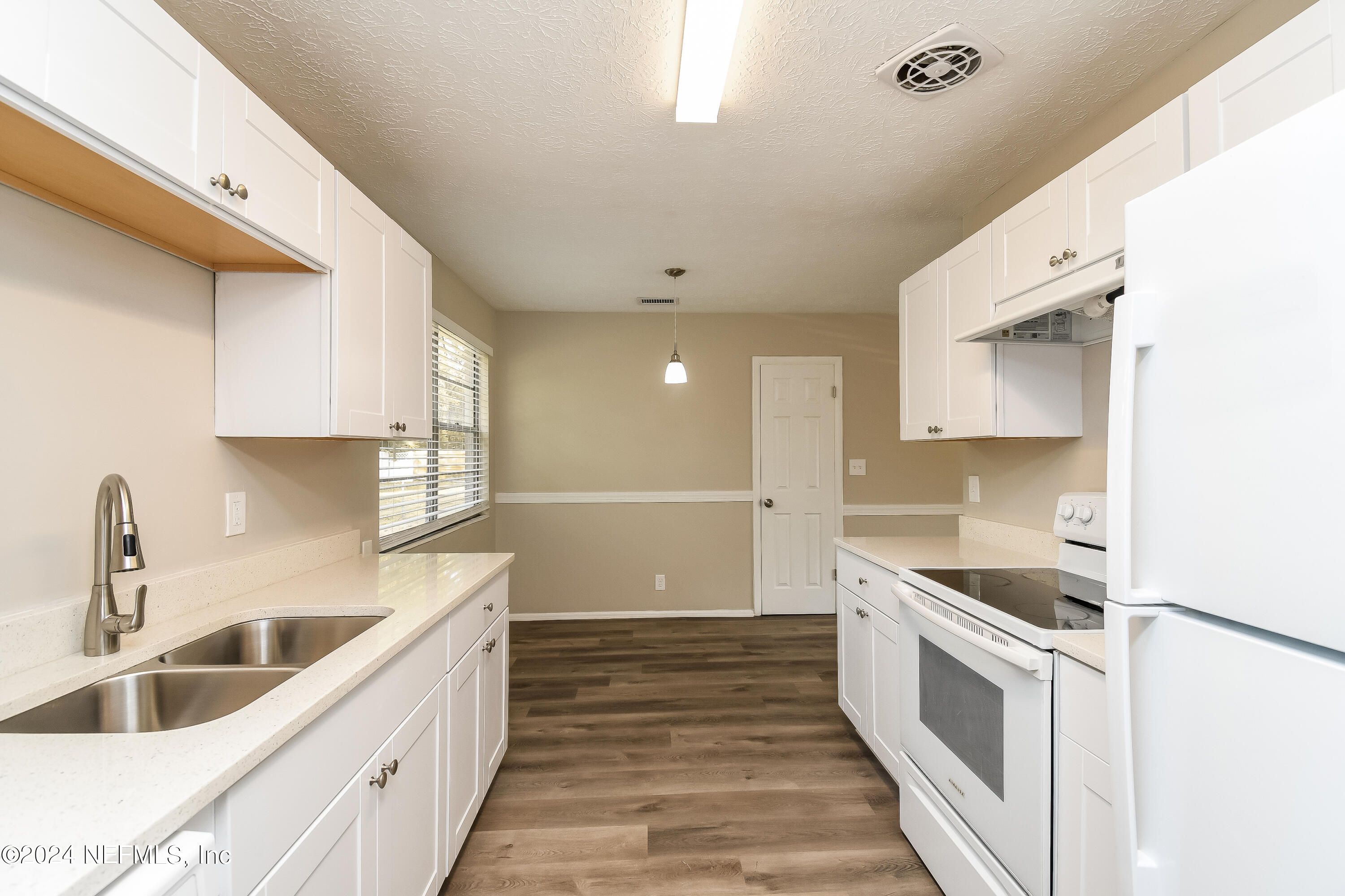 7217 Eudine Drive South Jacksonville, FL 32210 - Photo 5 of 16 a kitchen with granite countertop a sink and cabinets