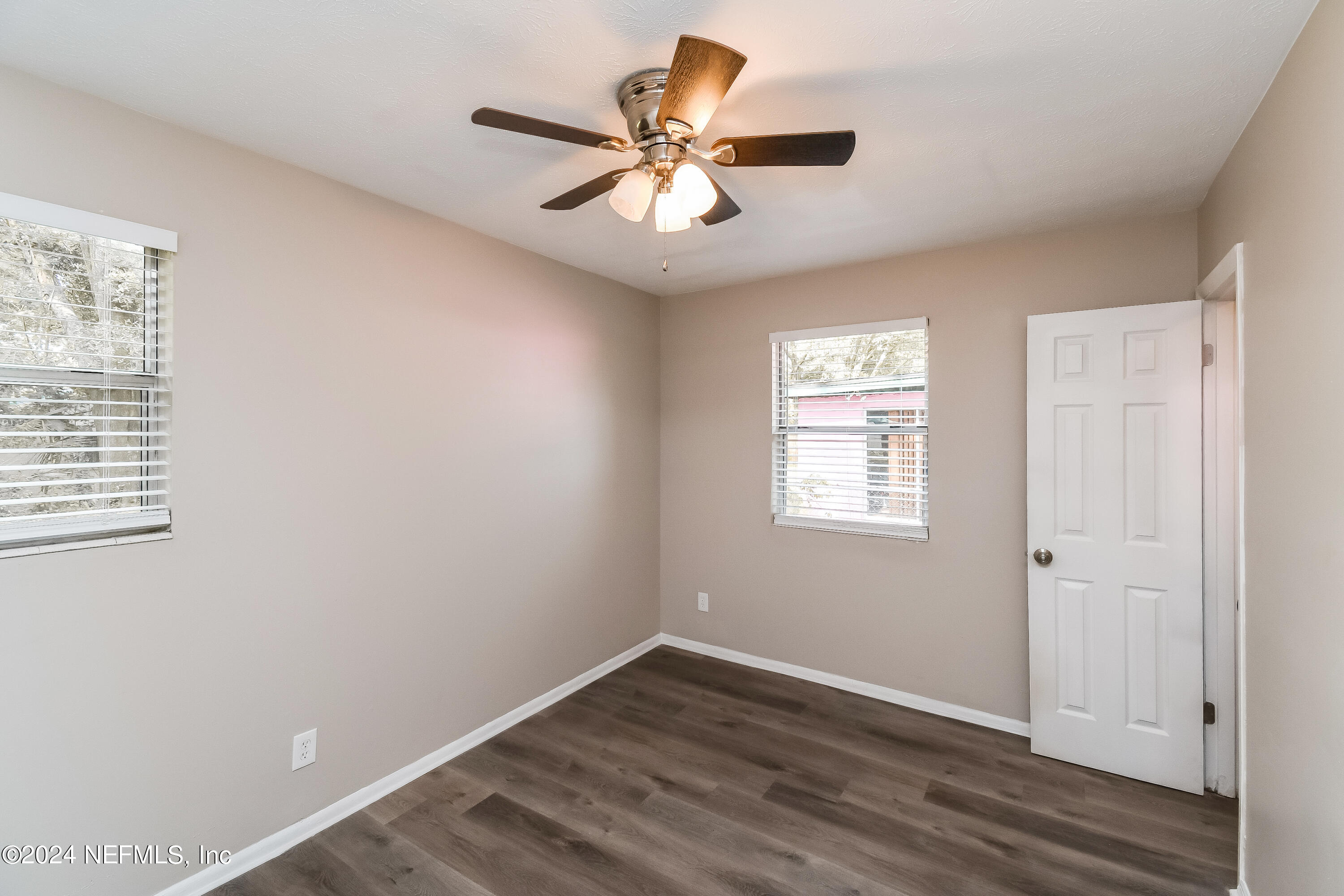 7217 Eudine Drive South Jacksonville, FL 32210 - Photo 6 of 16 wooden floor in an empty room with a window