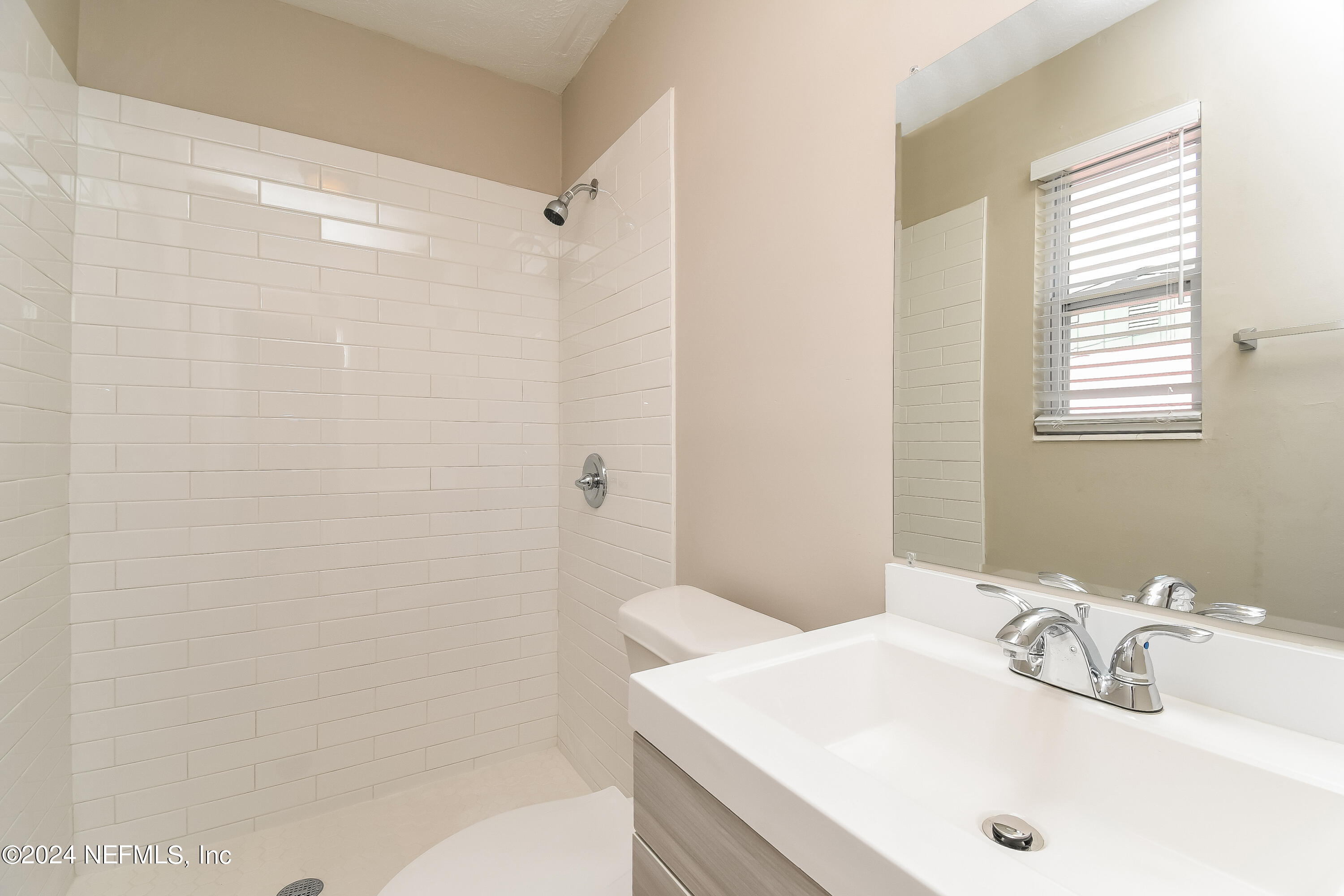 7217 Eudine Drive South Jacksonville, FL 32210 - Photo 8 of 16 a bathroom with a sink and a mirror