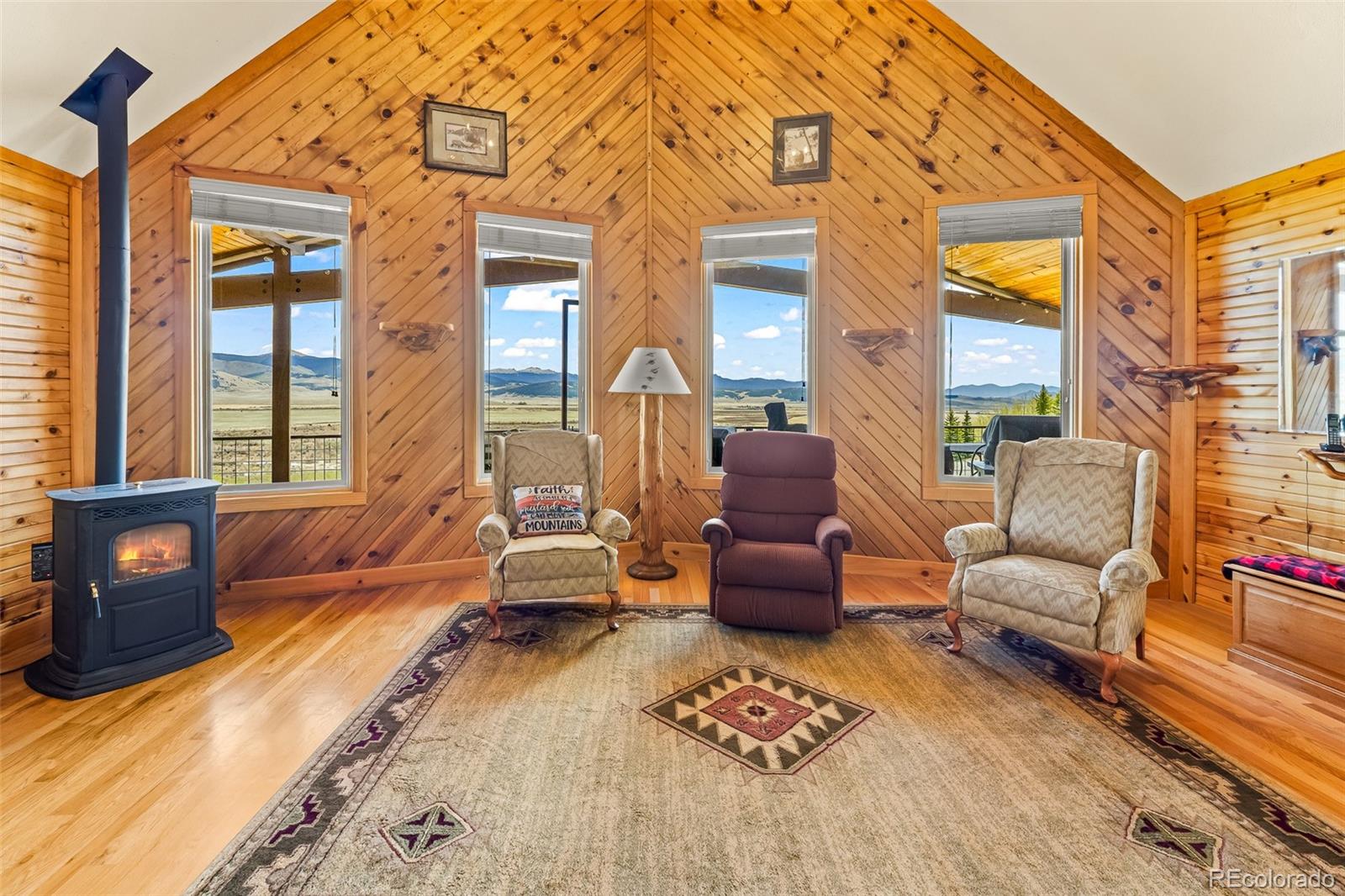 1163 Michigan Hill Road Jefferson, CO 80456 - Photo 14 of 48 a living room with furniture a rug and a floor to ceiling window