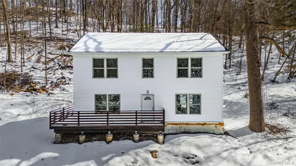 a view of a deck that has a table and chairs with wooden fence