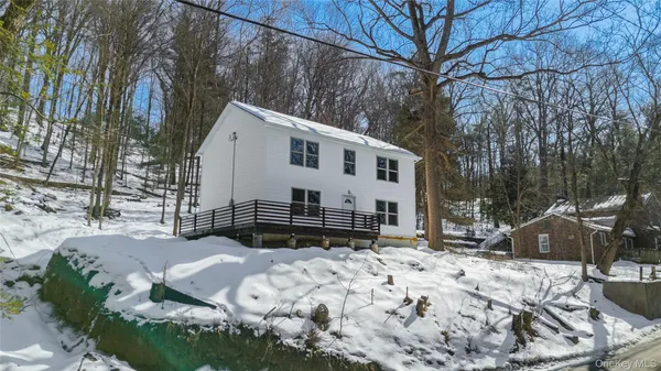 a view of a house with a yard covered in snow