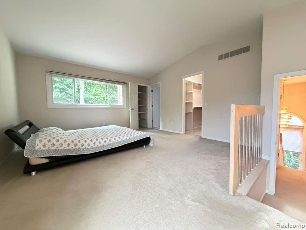 1154 Bluebird Drive Rochester, MI 48307 - Photo 23 of 34 Carpeted room with a vaulted ceiling