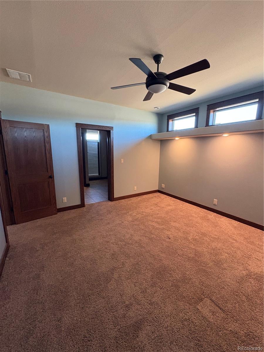 1925 Doe Valley Road Guffey, CO 80820 - Photo 16 of 32 a view of a livingroom with a ceiling fan and window