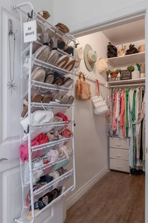 a view of walk in closet with clothes and shoes