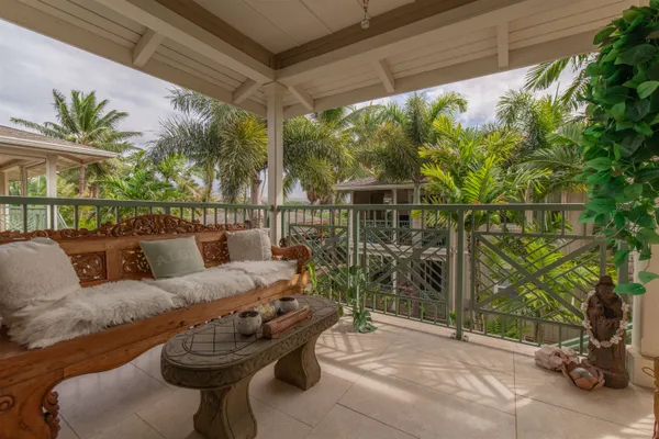 a roof deck with couch and potted plants