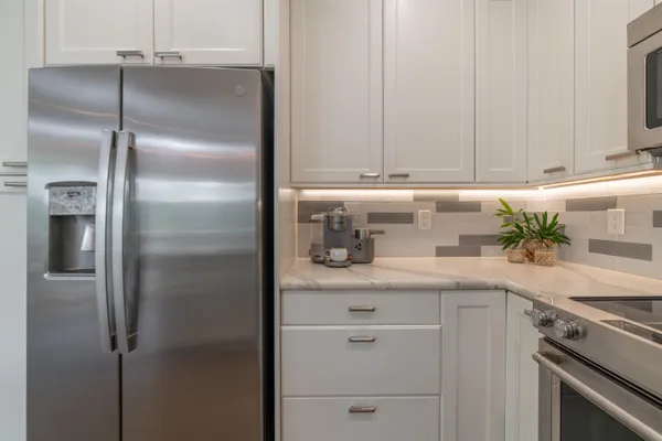 a kitchen with a refrigerator and cabinets