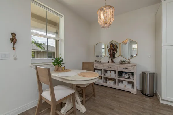 a view of a dining room with furniture a chandelier and wooden floor