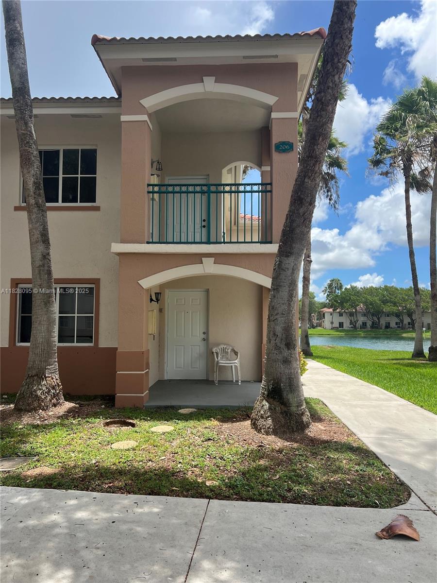 2921 Southeast 12th Road, Unit 20656 Homestead, FL 33035 - Photo 1 of 9 a front view of house with yard