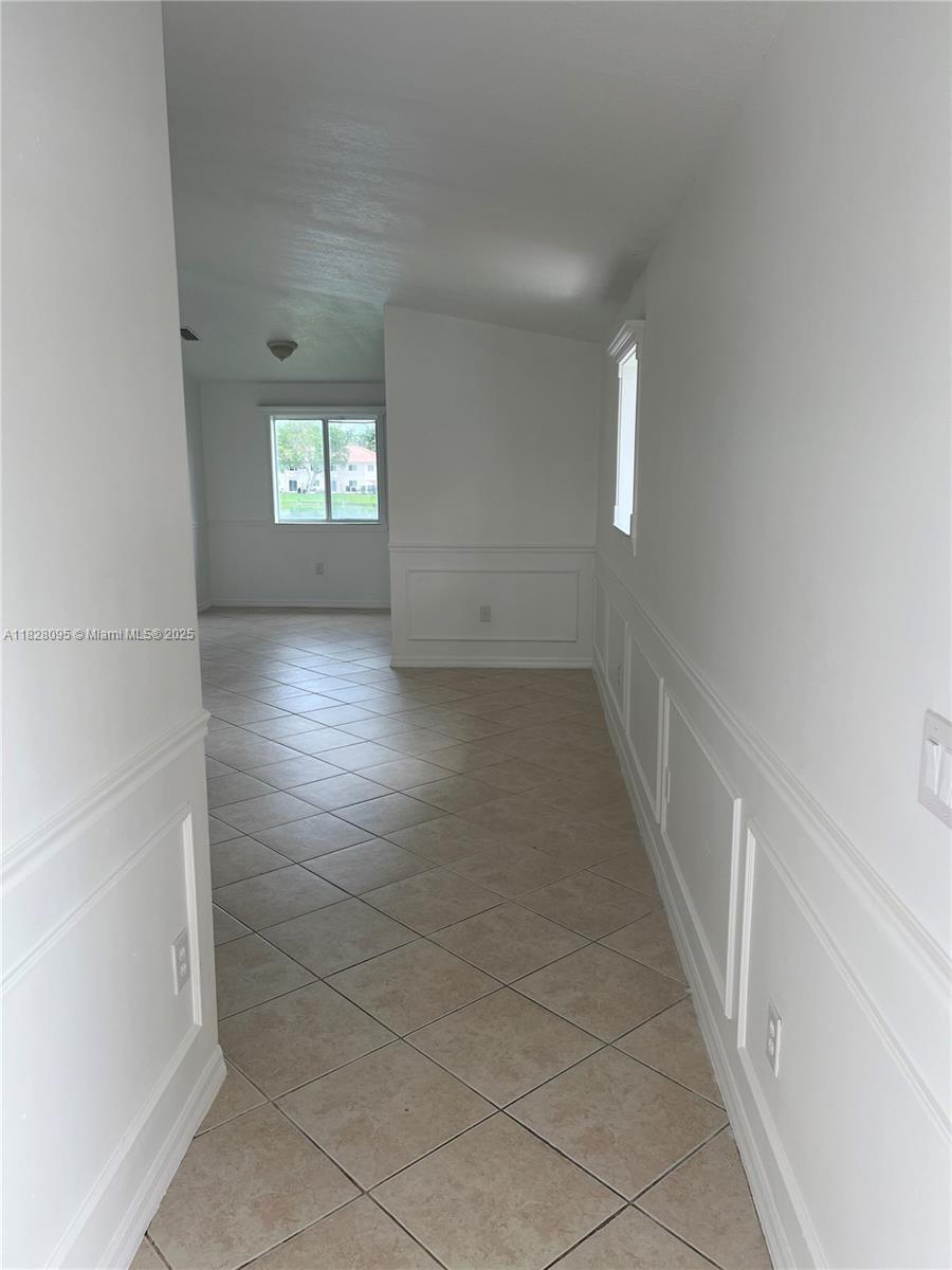 2921 Southeast 12th Road, Unit 20656 Homestead, FL 33035 - Photo 2 of 9 wooden floor in an empty room with a window