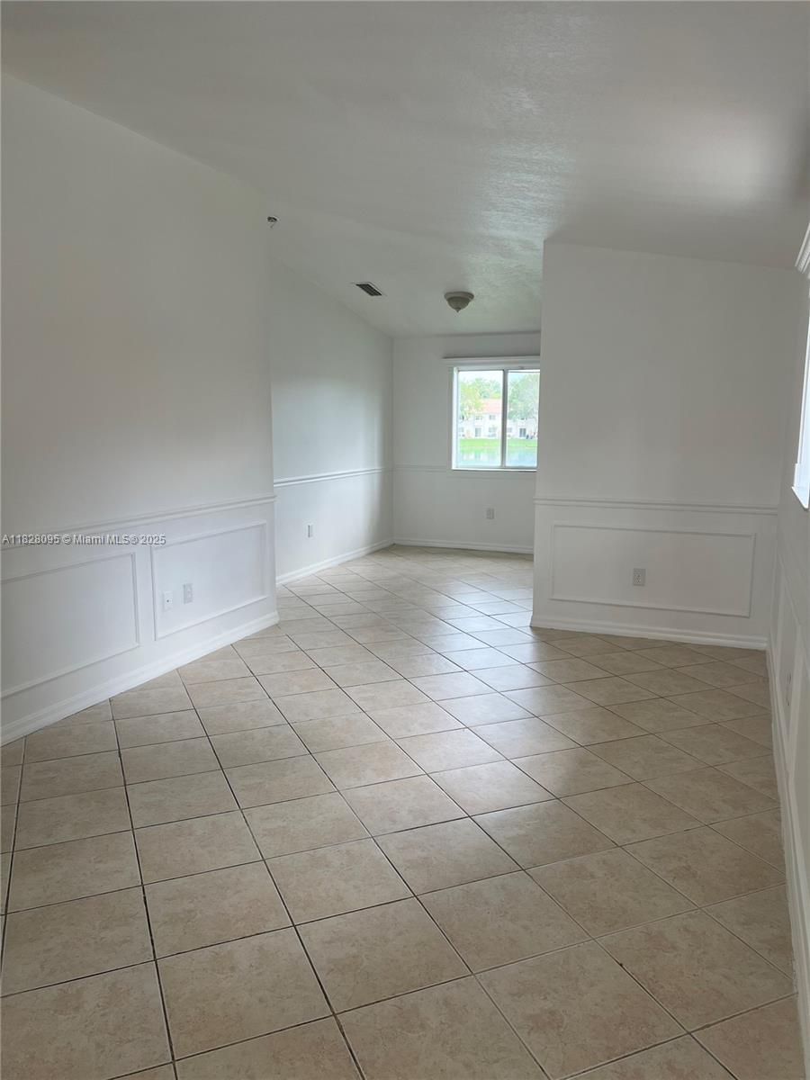 2921 Southeast 12th Road, Unit 20656 Homestead, FL 33035 - Photo 3 of 9 an empty room with white walls and windows