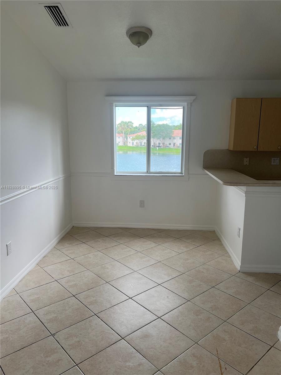 2921 Southeast 12th Road, Unit 20656 Homestead, FL 33035 - Photo 4 of 9 a view of an empty room with a window