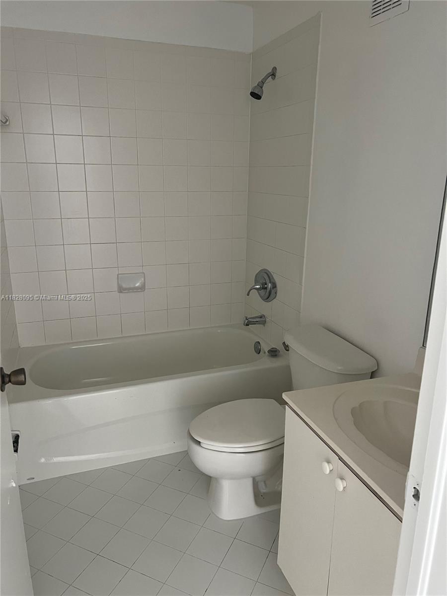 2921 Southeast 12th Road, Unit 20656 Homestead, FL 33035 - Photo 8 of 9 a white toilet sitting next to a bath tub