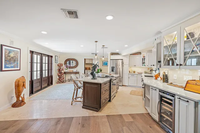 a kitchen that has a lot of cabinets a sink and appliances in it