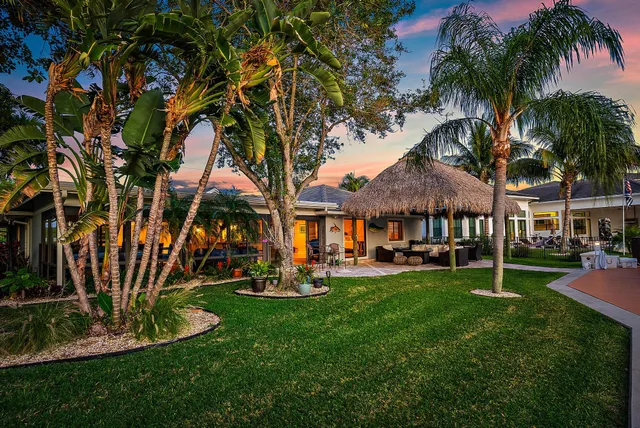 a view of a house with sitting area and garden