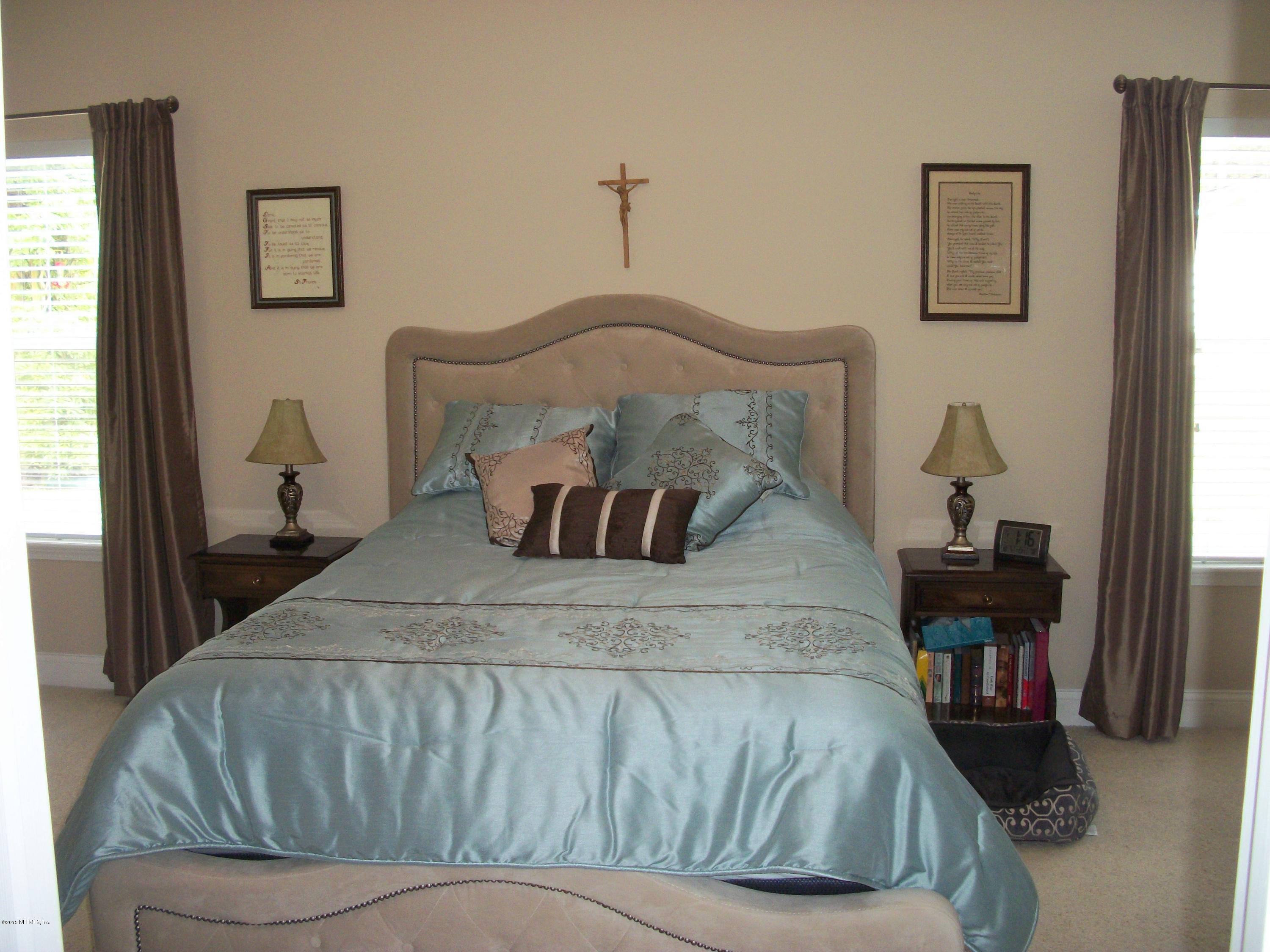 96057 Maranatha Road Yulee, FL 32097 - Photo 12 of 25 a bedroom with a bed and wooden floor