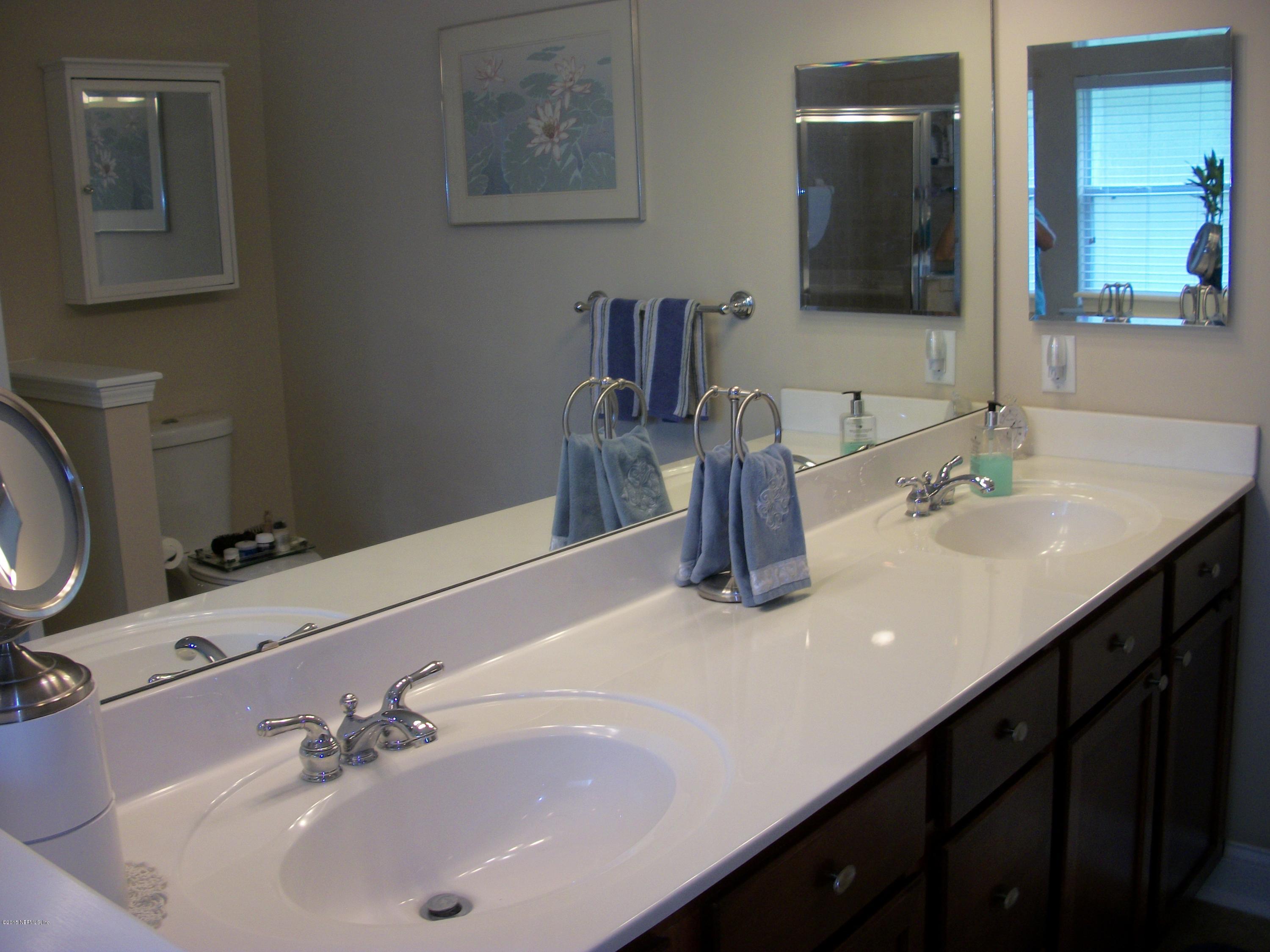 96057 Maranatha Road Yulee, FL 32097 - Photo 13 of 25 a bathroom with a sink and a mirror