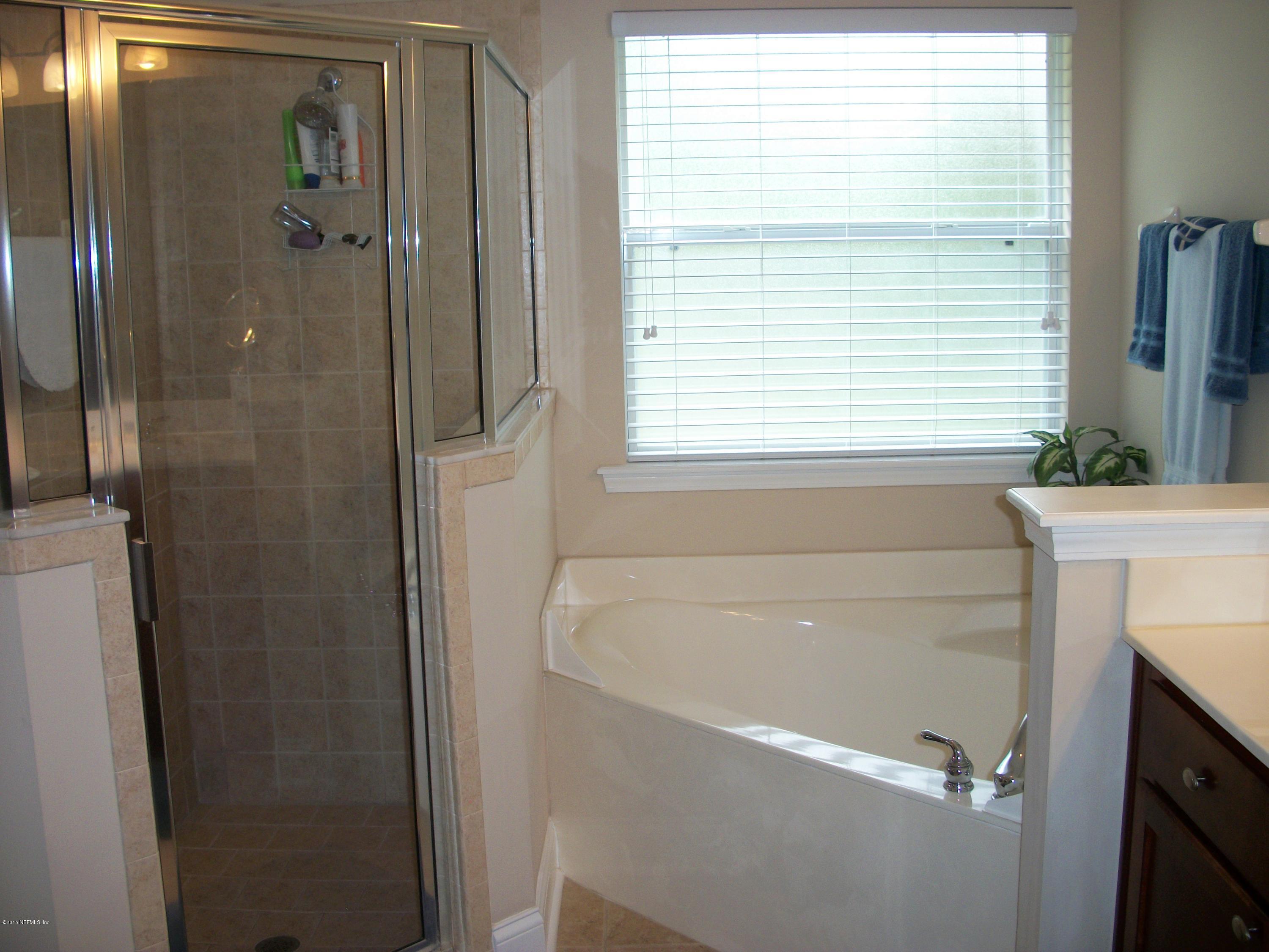 96057 Maranatha Road Yulee, FL 32097 - Photo 14 of 25 a bathroom with a bathtub and a shower