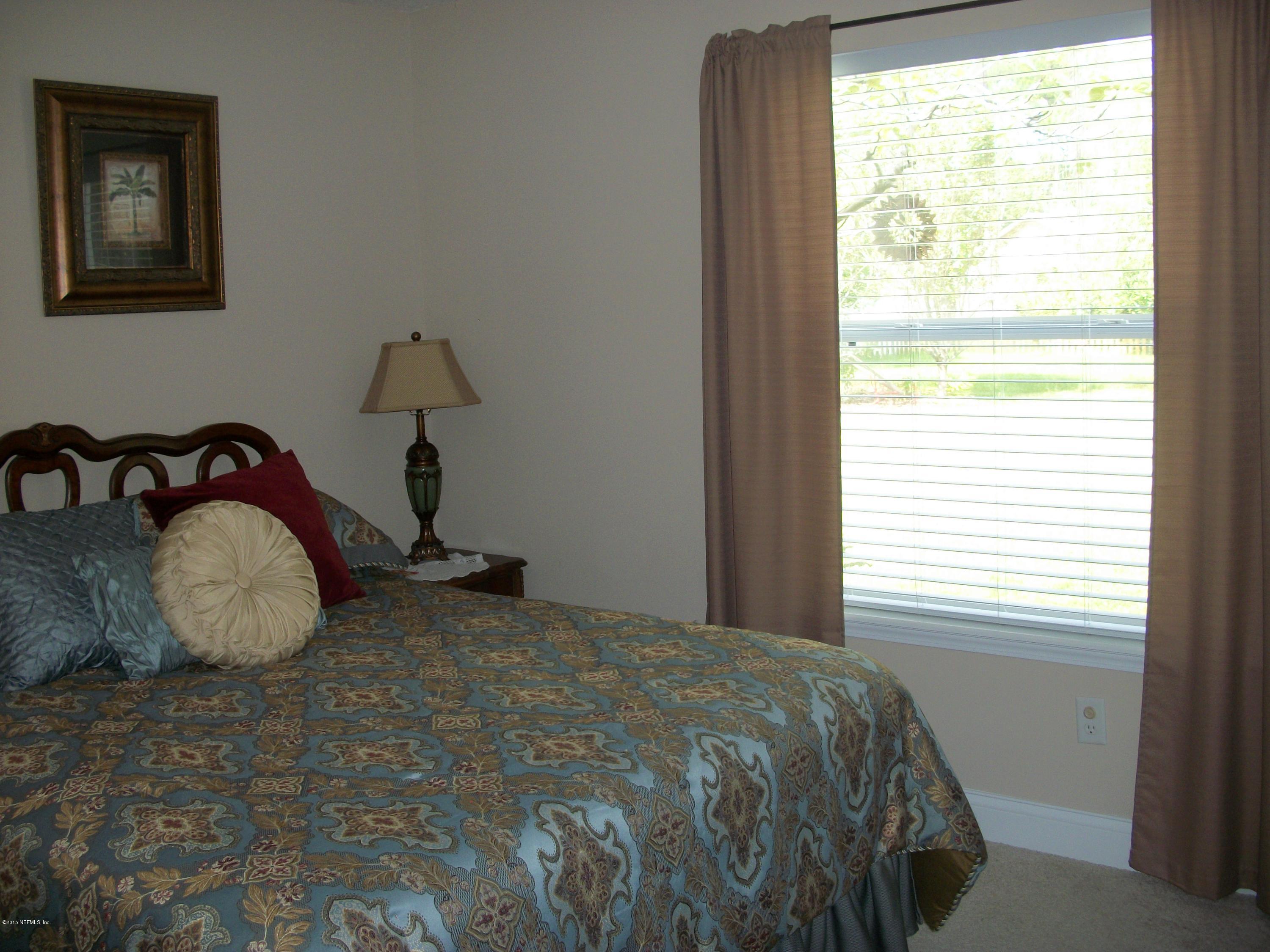 96057 Maranatha Road Yulee, FL 32097 - Photo 17 of 25 a bedroom with a bed and window