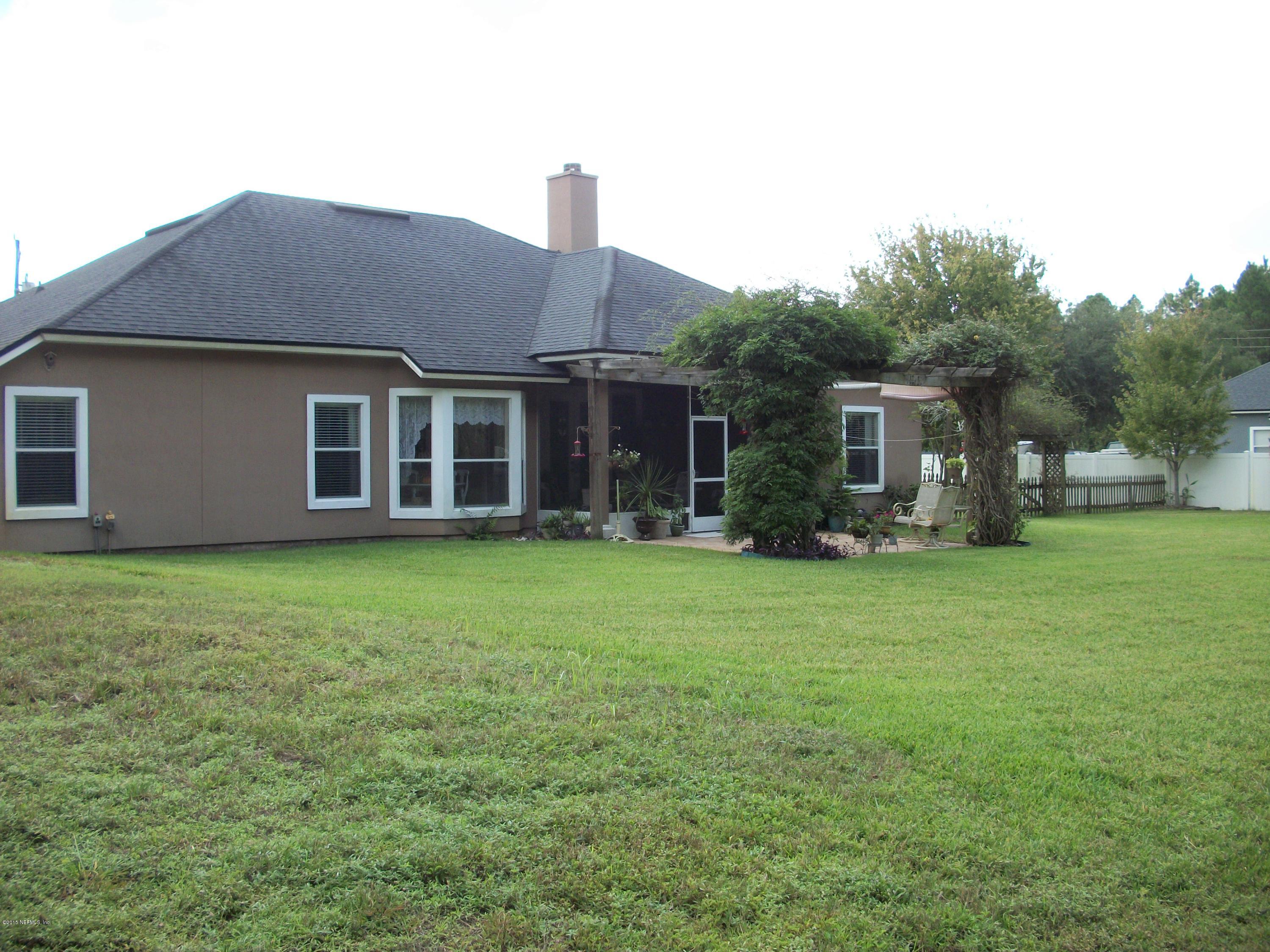 96057 Maranatha Road Yulee, FL 32097 - Photo 18 of 25 a front view of house with yard and green space