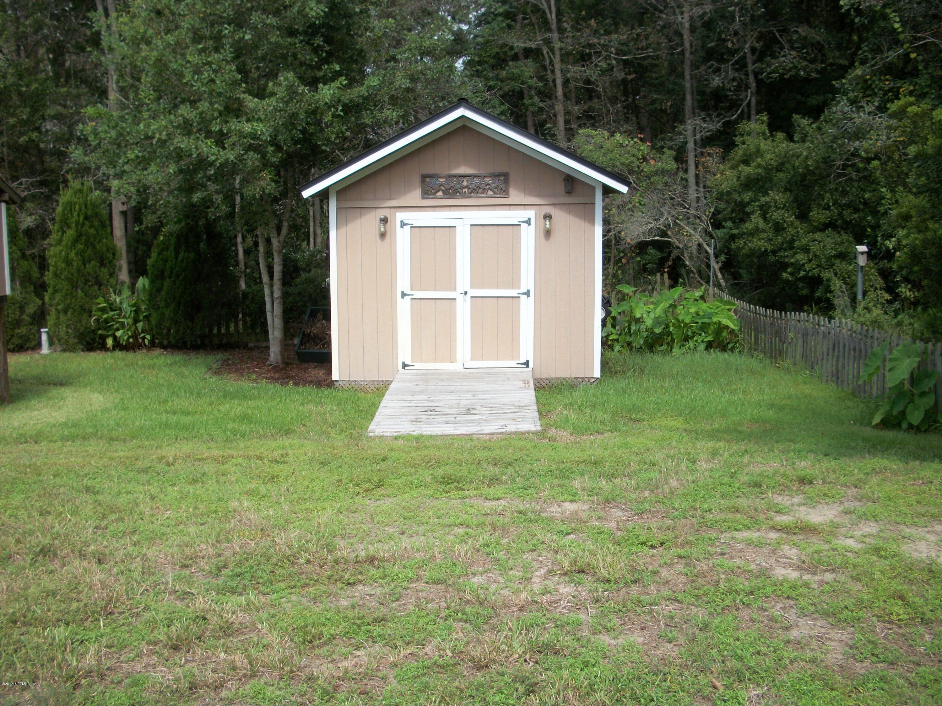 96057 Maranatha Road Yulee, FL 32097 - Photo 20 of 25 a front view of a house with yard and green space