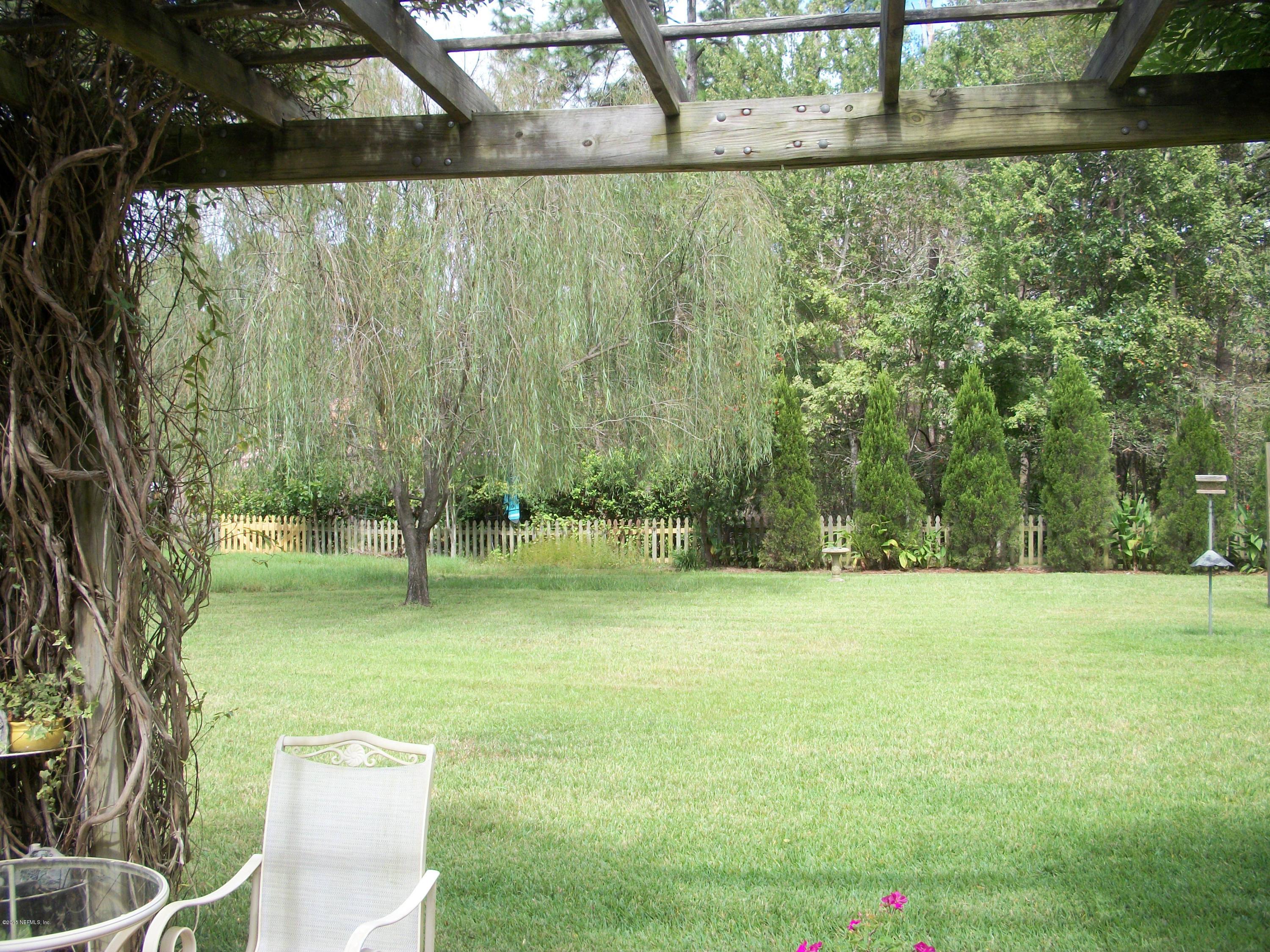96057 Maranatha Road Yulee, FL 32097 - Photo 23 of 25 a view of open space with a yard