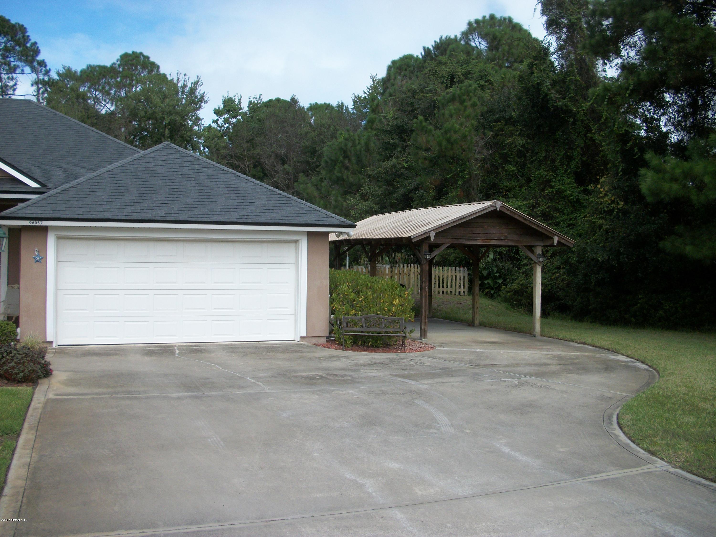 96057 Maranatha Road Yulee, FL 32097 - Photo 24 of 25 a house with trees in the background
