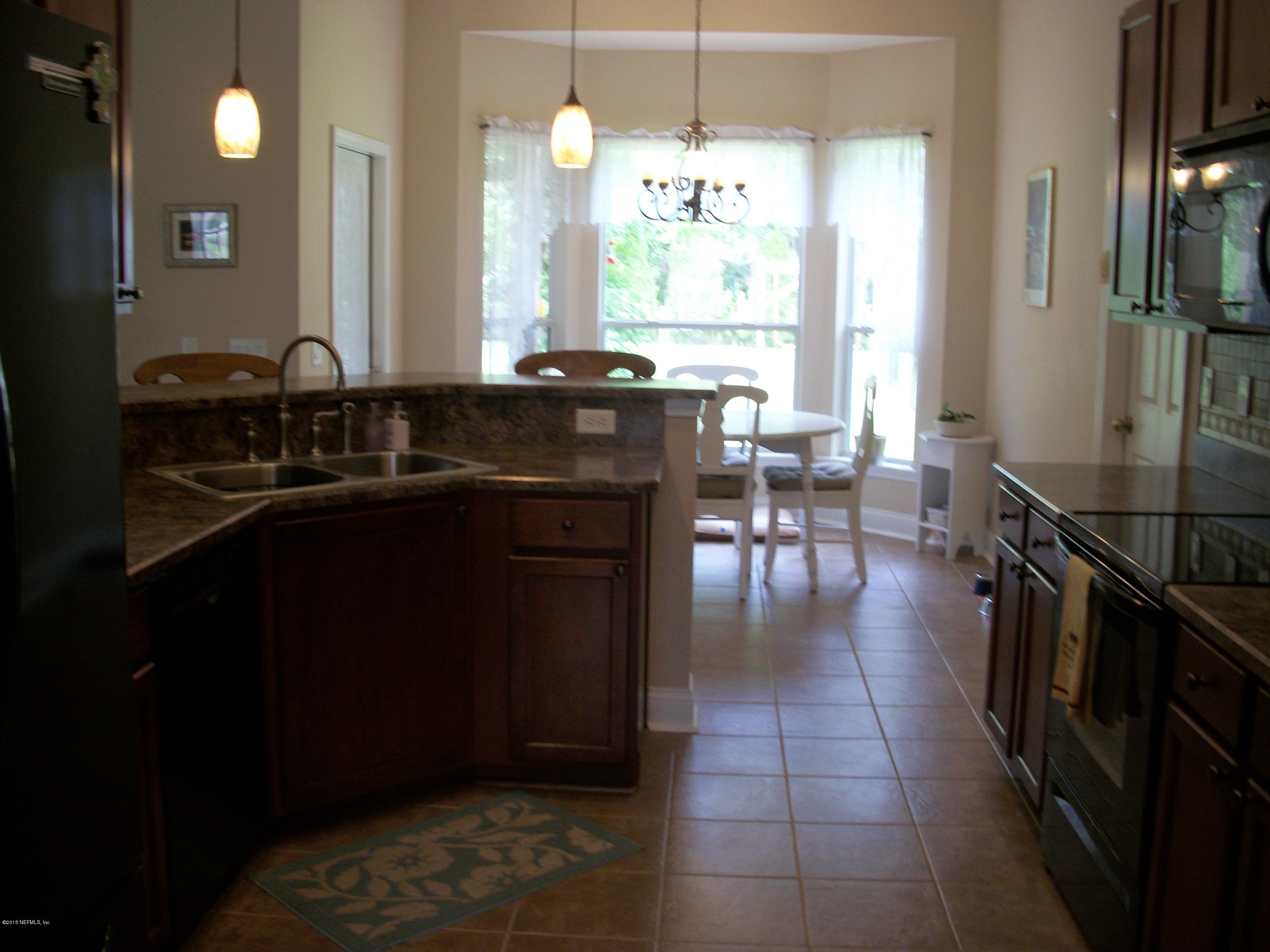 96057 Maranatha Road Yulee, FL 32097 - Photo 8 of 25 a kitchen with a sink appliances and cabinets