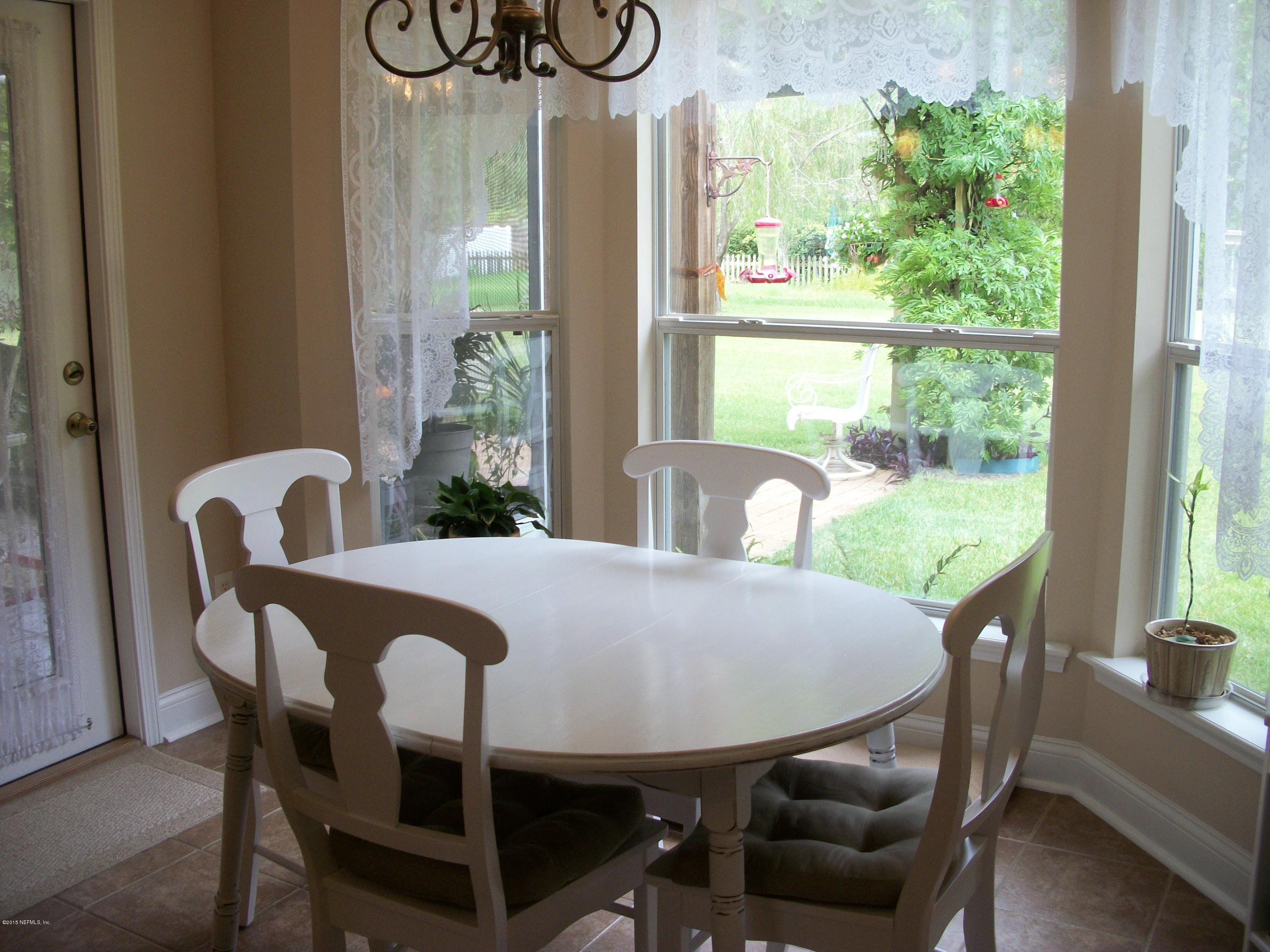 96057 Maranatha Road Yulee, FL 32097 - Photo 9 of 25 a view of a dining room with furniture window and outside view