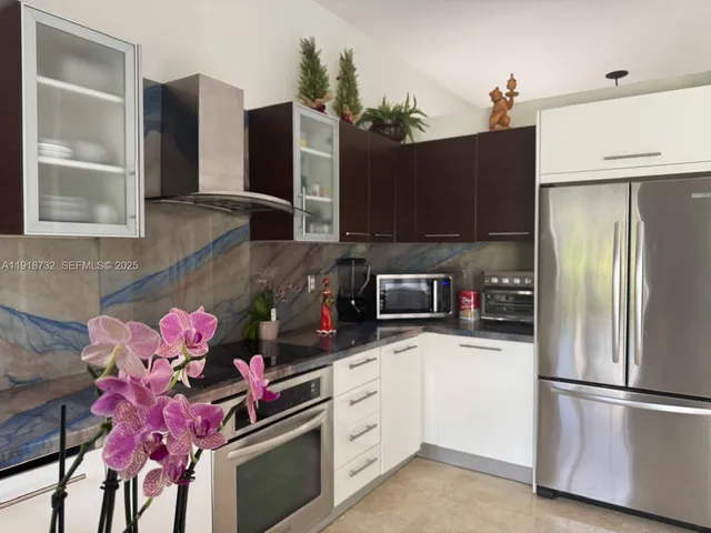 a kitchen with a sink appliances and cabinets