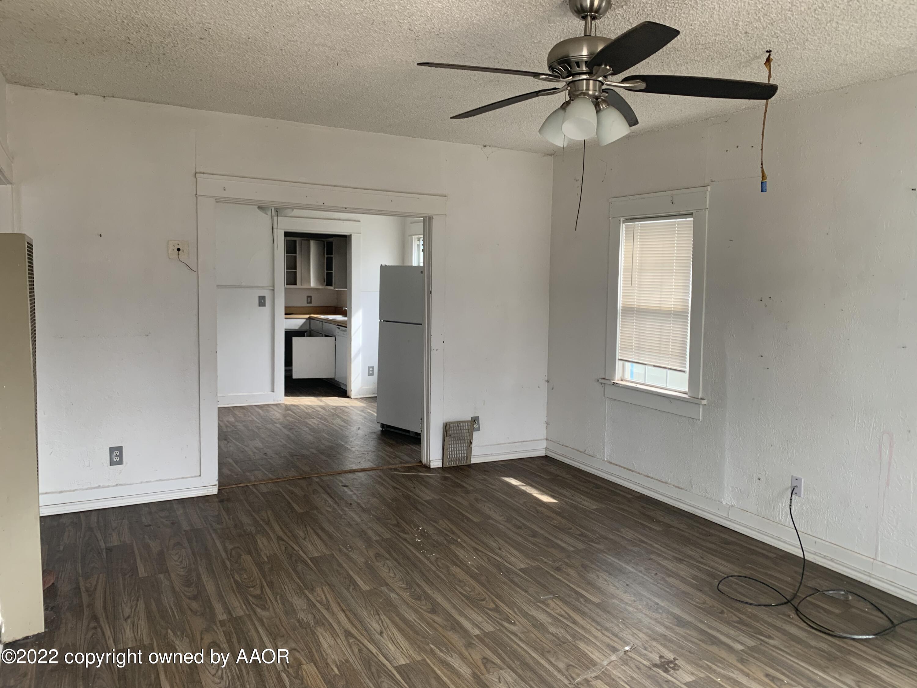 3707 South Tyler Street Amarillo, TX 79110 - Photo 4 of 7 a view of a livingroom with a ceiling fan and hardwood floor