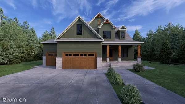 a front view of a house with yard and green space