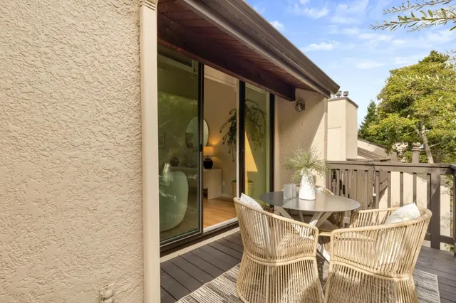 a view of an outdoor dining space with a glass door