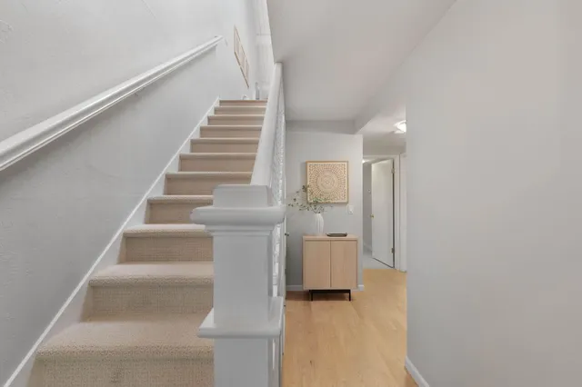 a view of entryway and hall with wooden floor