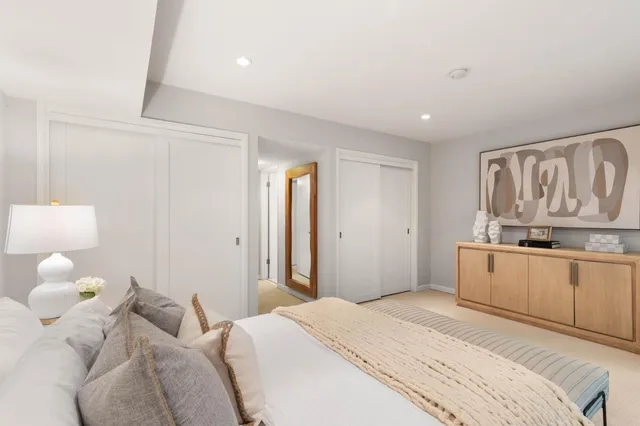 a bedroom with a bed and cabinets