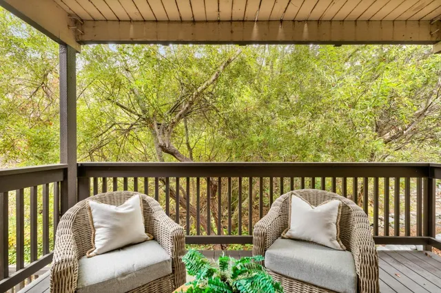 a living room with furniture a lamp and a window