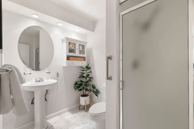 a kitchen with a refrigerator and white cabinets
