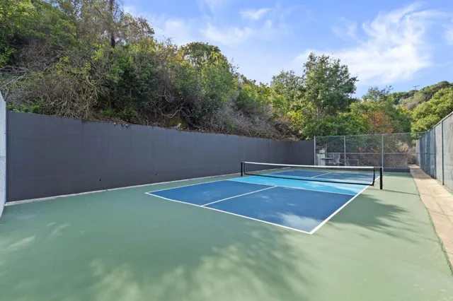 a room with patio furniture and a large window