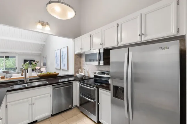 a kitchen with a sink and stainless steel appliances