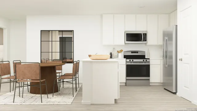 a kitchen with stainless steel appliances kitchen island granite countertop a stove top oven microwave and cabinets