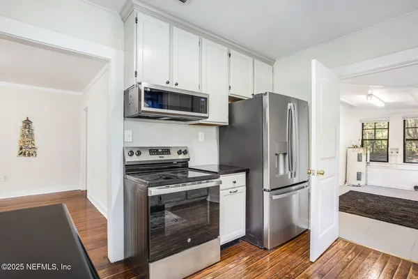 a kitchen with stainless steel appliances a refrigerator stove and microwave
