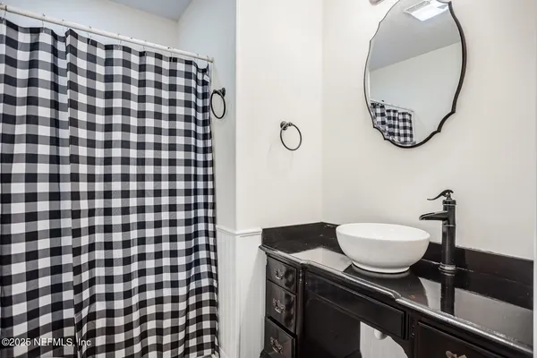a bathroom with a sink and a mirror