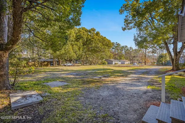a view of a yard with large trees