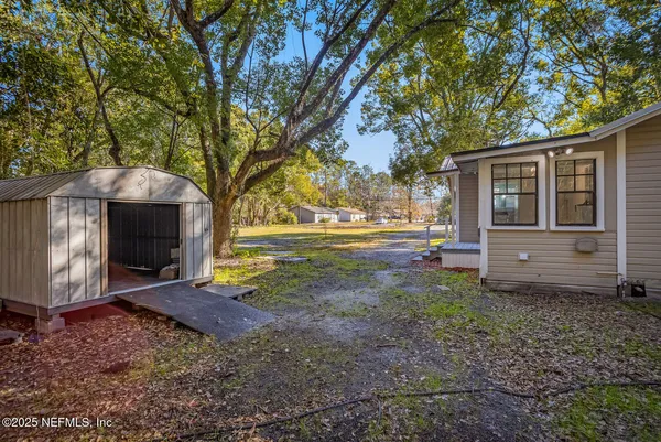 a backyard of a house with barbeque oven fire pit table and chairs
