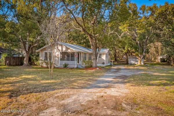 a view of a house with a large tree