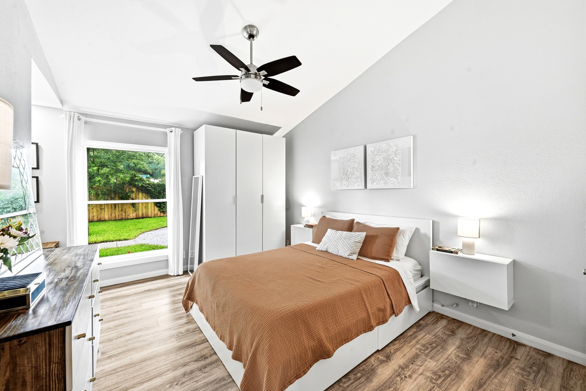 7110 Windrift Way Austin, TX 78745 - Photo 15 of 30 Hardwood-style flooring and a vaulted ceiling create an inviting, open atmosphere in this bedroom.