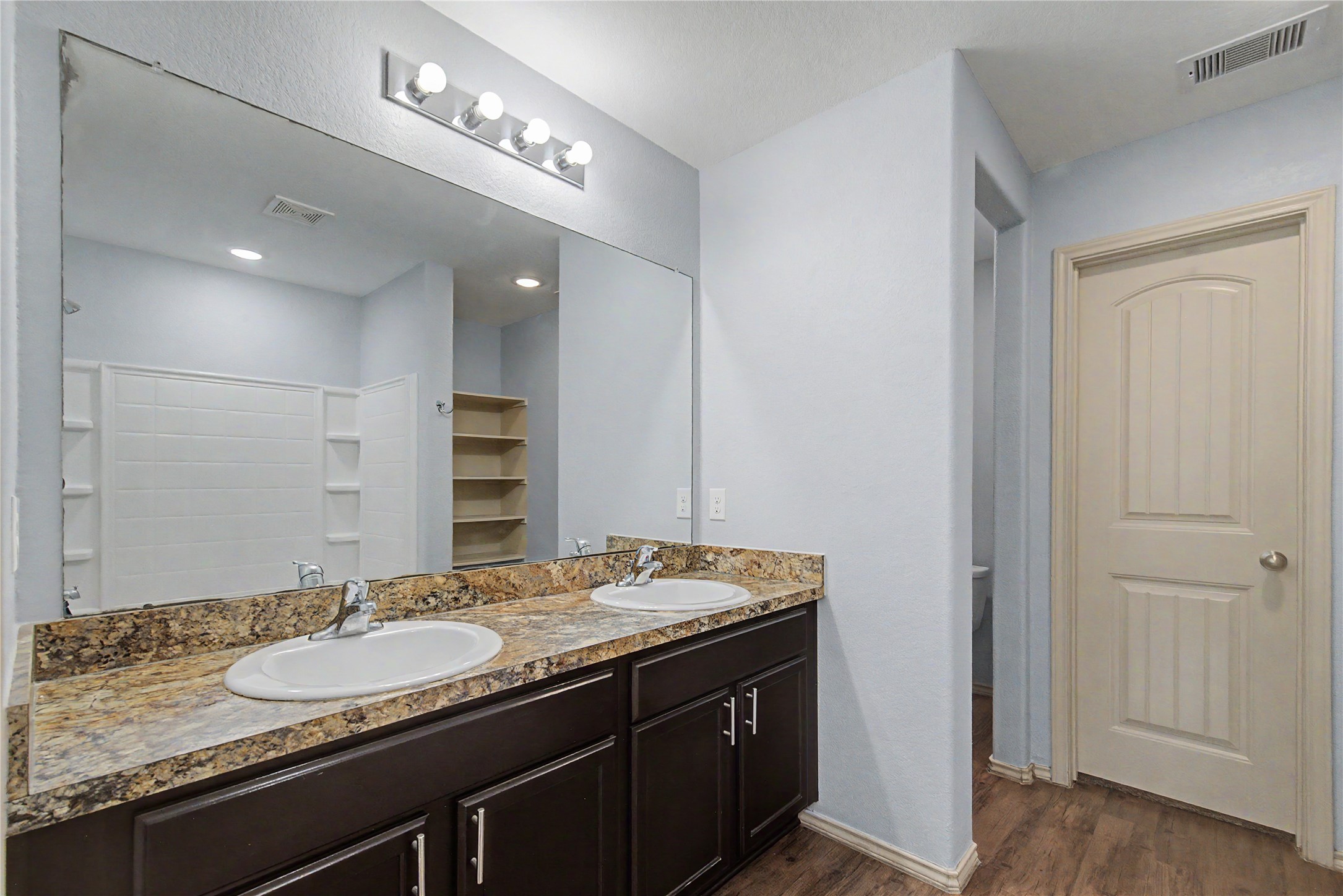 16430 Rodeo River Road Houston, TX 77049 - Photo 29 of 34 a bathroom with a granite countertop sink and a mirror