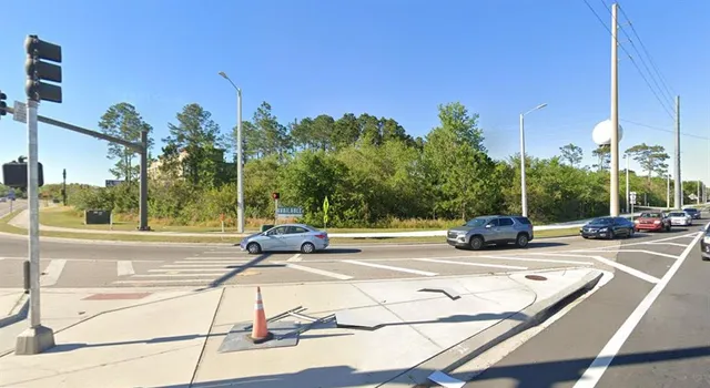 a view of a street with cars on road