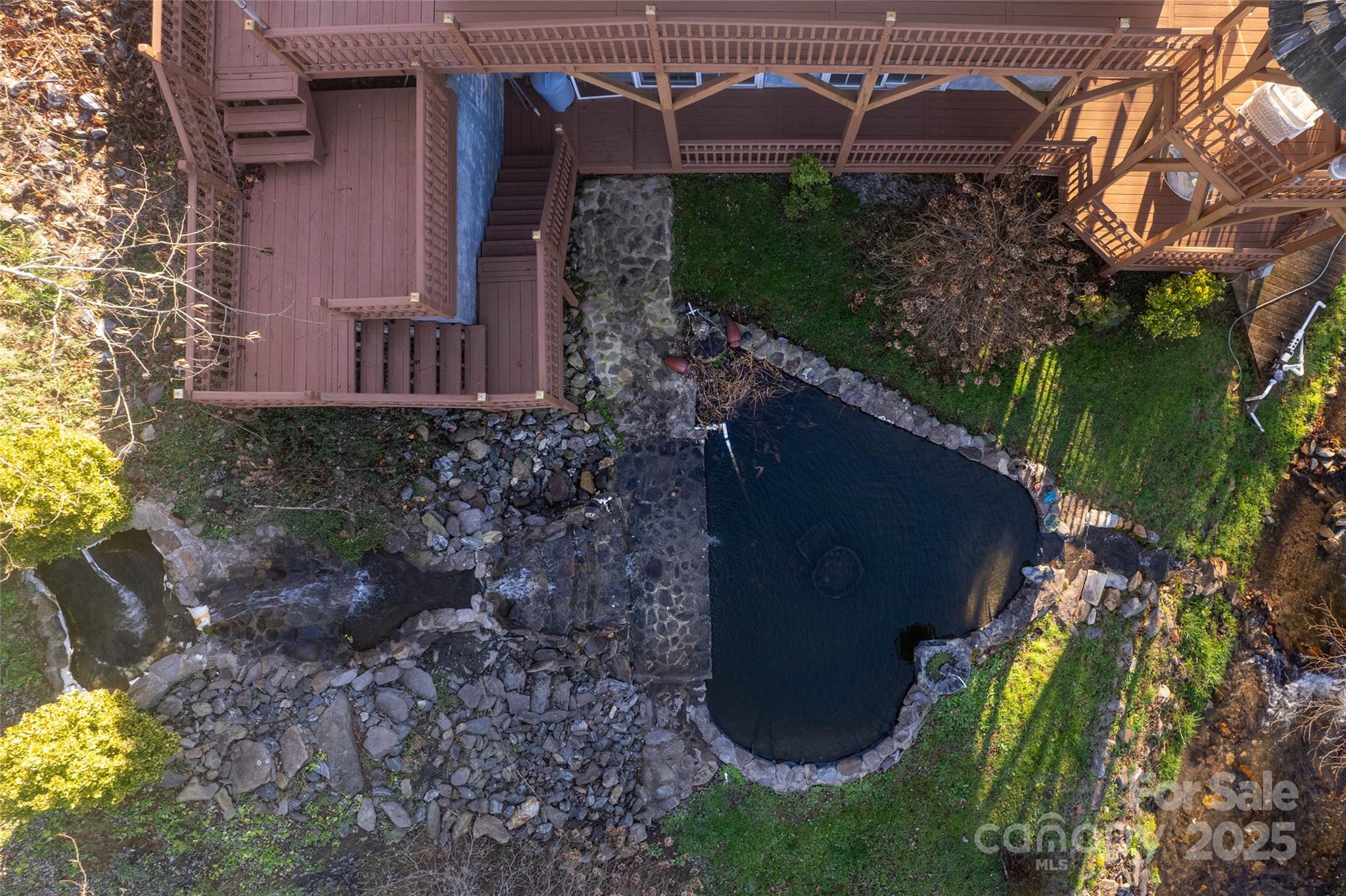 814 Barkers Creek Road Whittier, NC 28789 - Photo 16 of 40 a view of a backyard with plants and a fountain