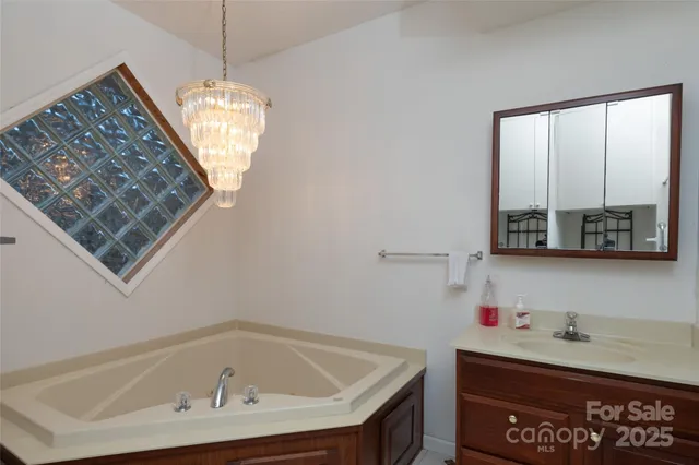 a view of a livingroom with furniture and chandelier fan